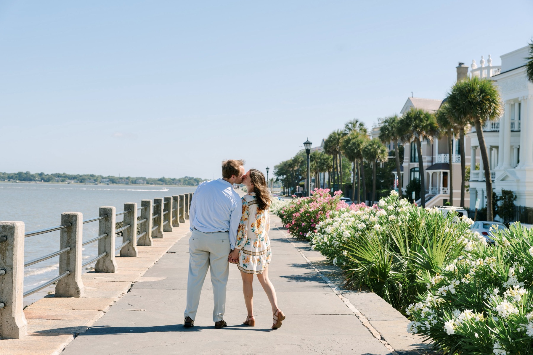 The couple walking beside the water